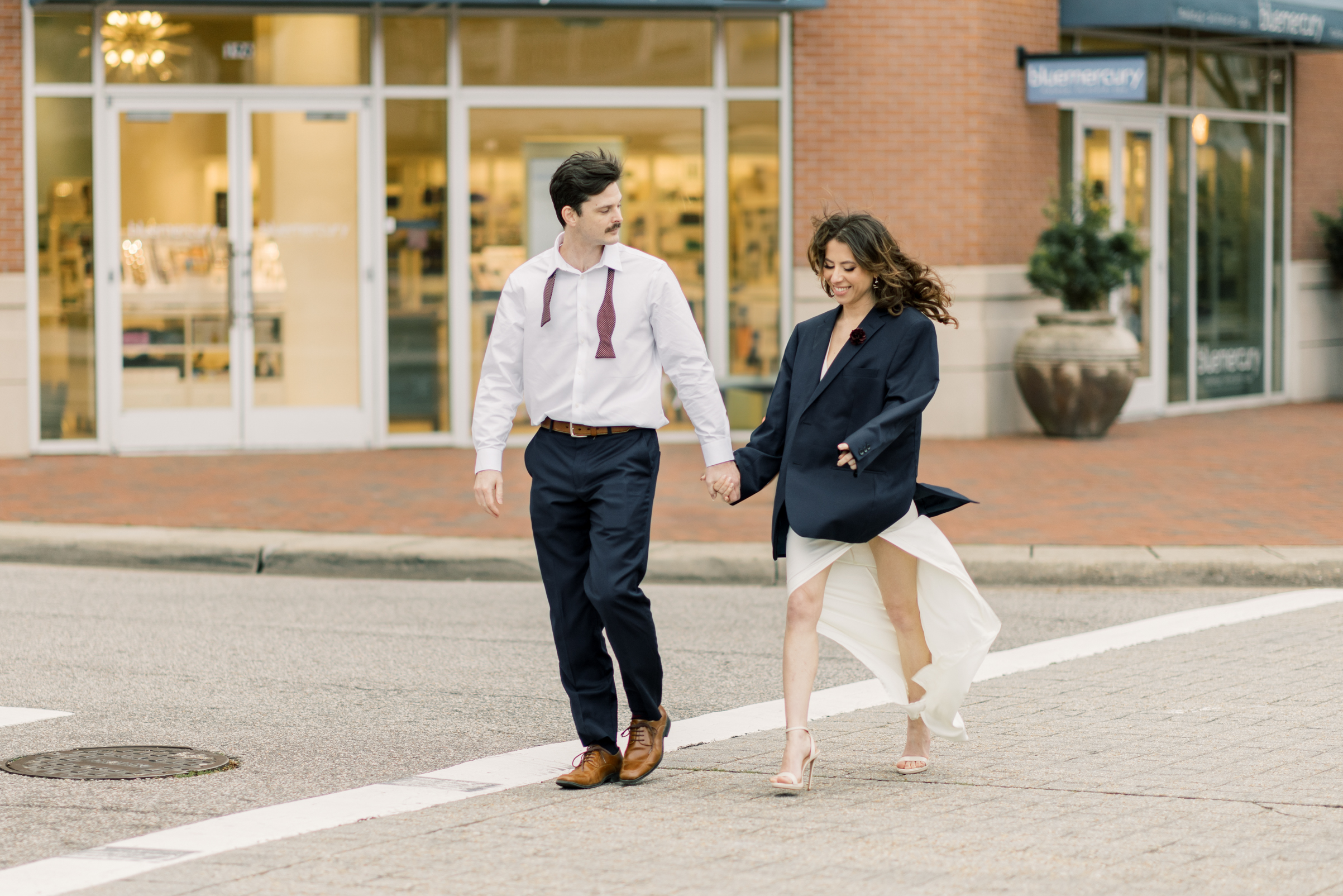 Virginia Beach Engagement photography of a couple crossing the street at a crosswalk  