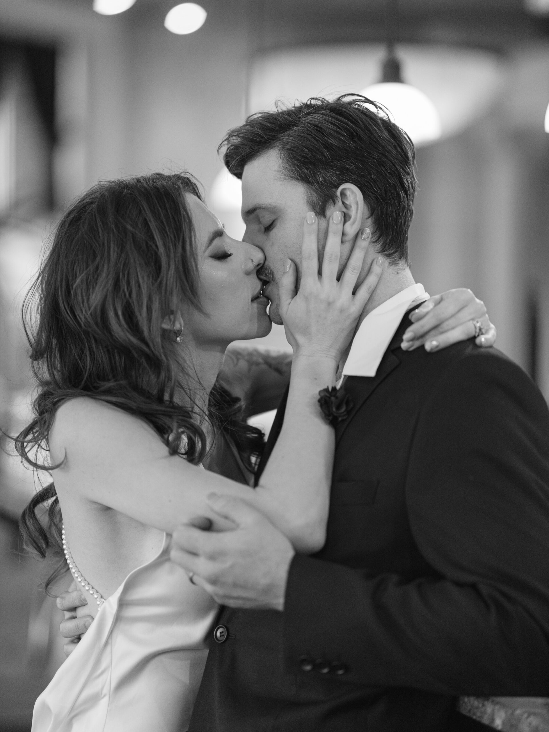 Close up black and white Virginia Beach engagement photography of a bride and groom kissing
