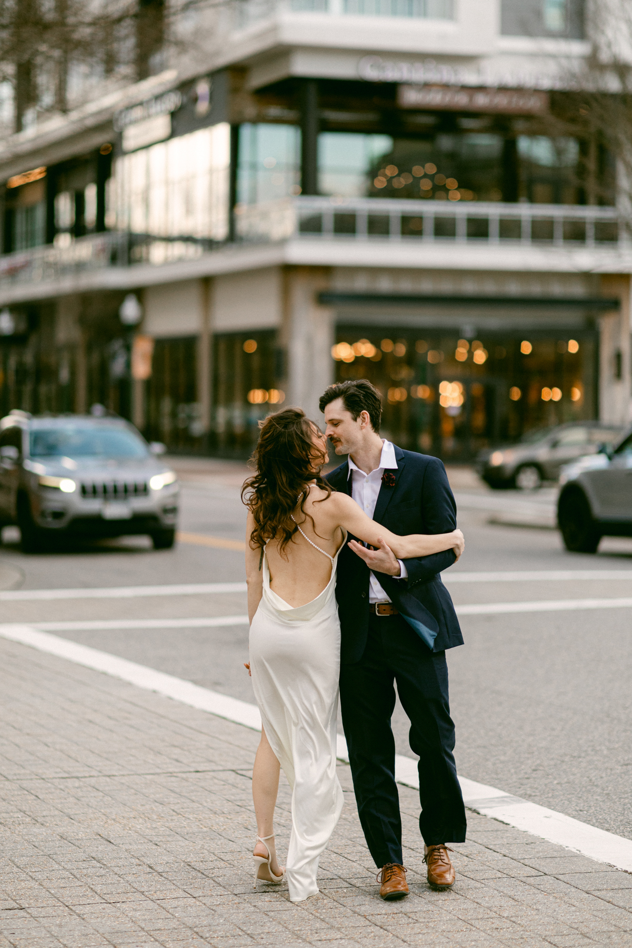Engagement photography of a couple crossing the street at a crosswalk  taken by Virginia Beach Engagement photographers Glenn & Nadya