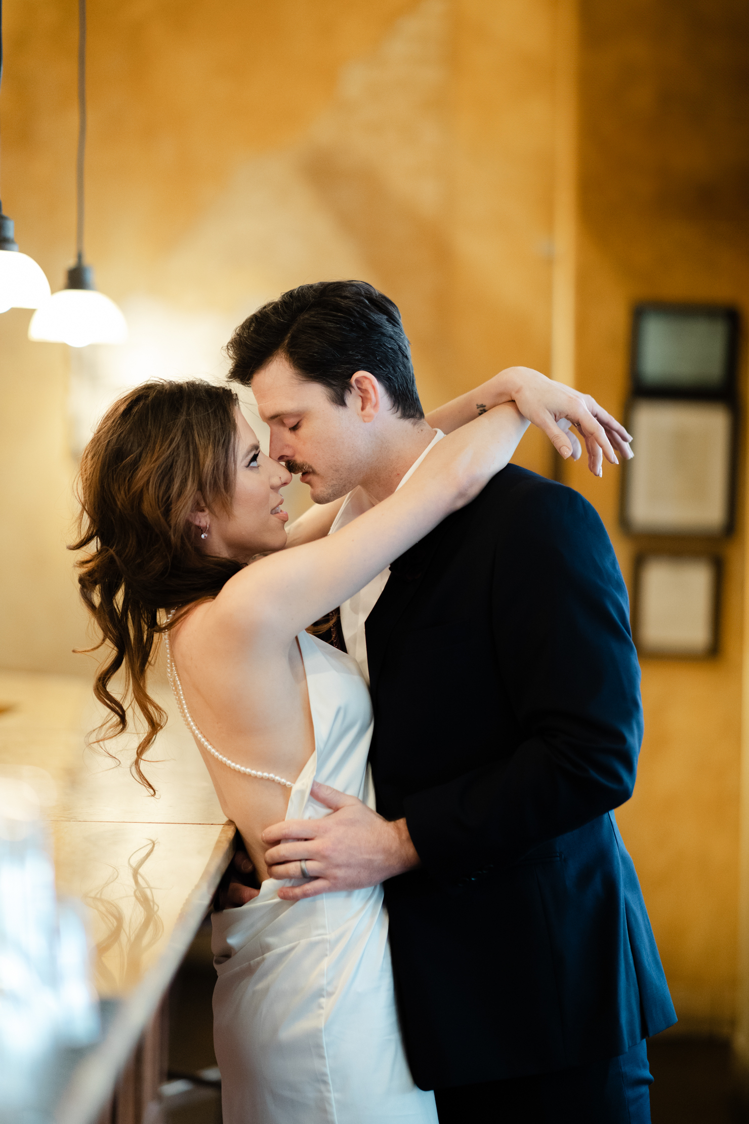 Close up Virginia Beach engagement photography of a bride and groom facing each other and almost kissing