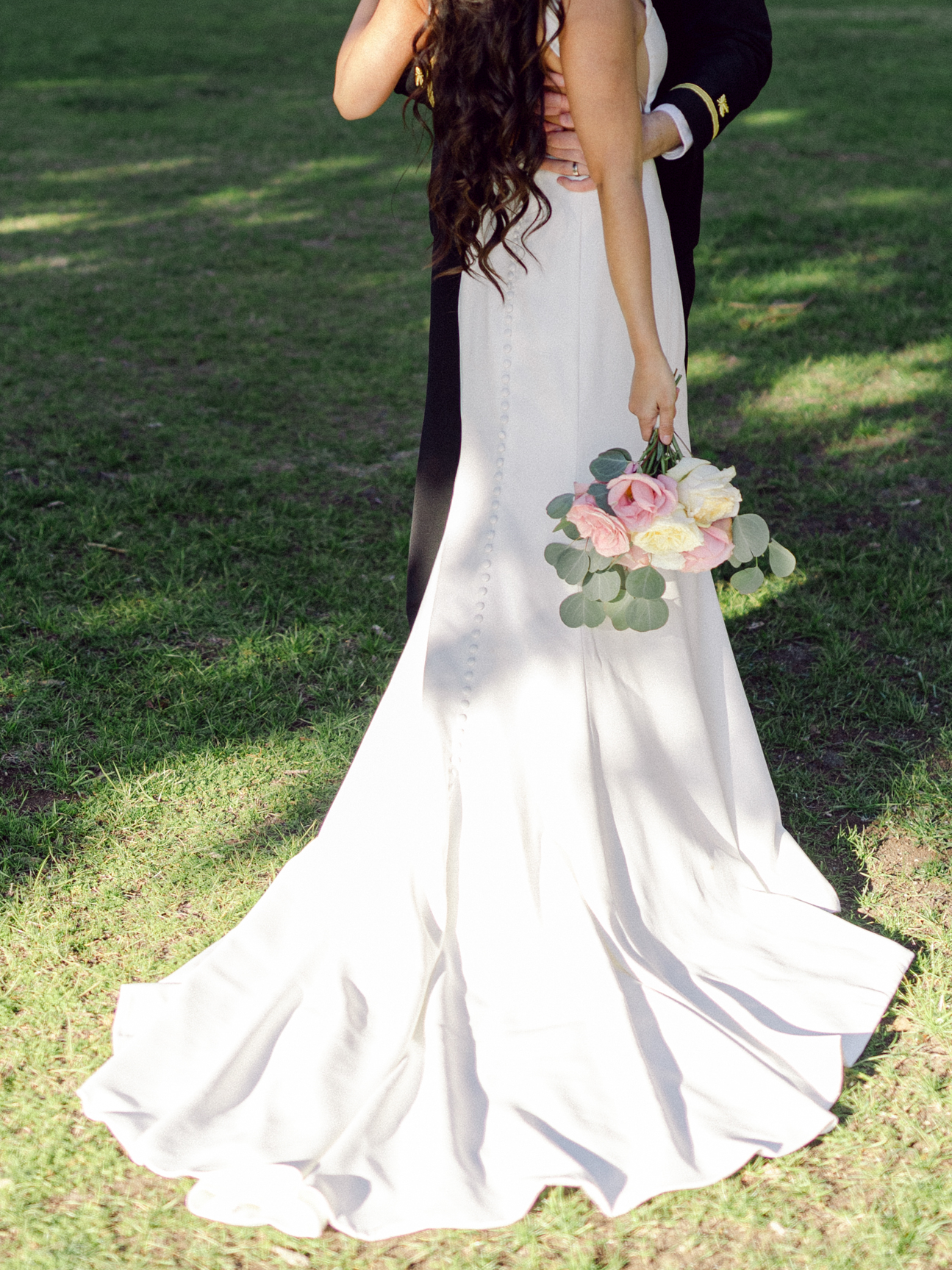 Detail wedding photography of a bride's dress and a bouquet taken by Virginia wedding photographers Glenn and Nadya. 