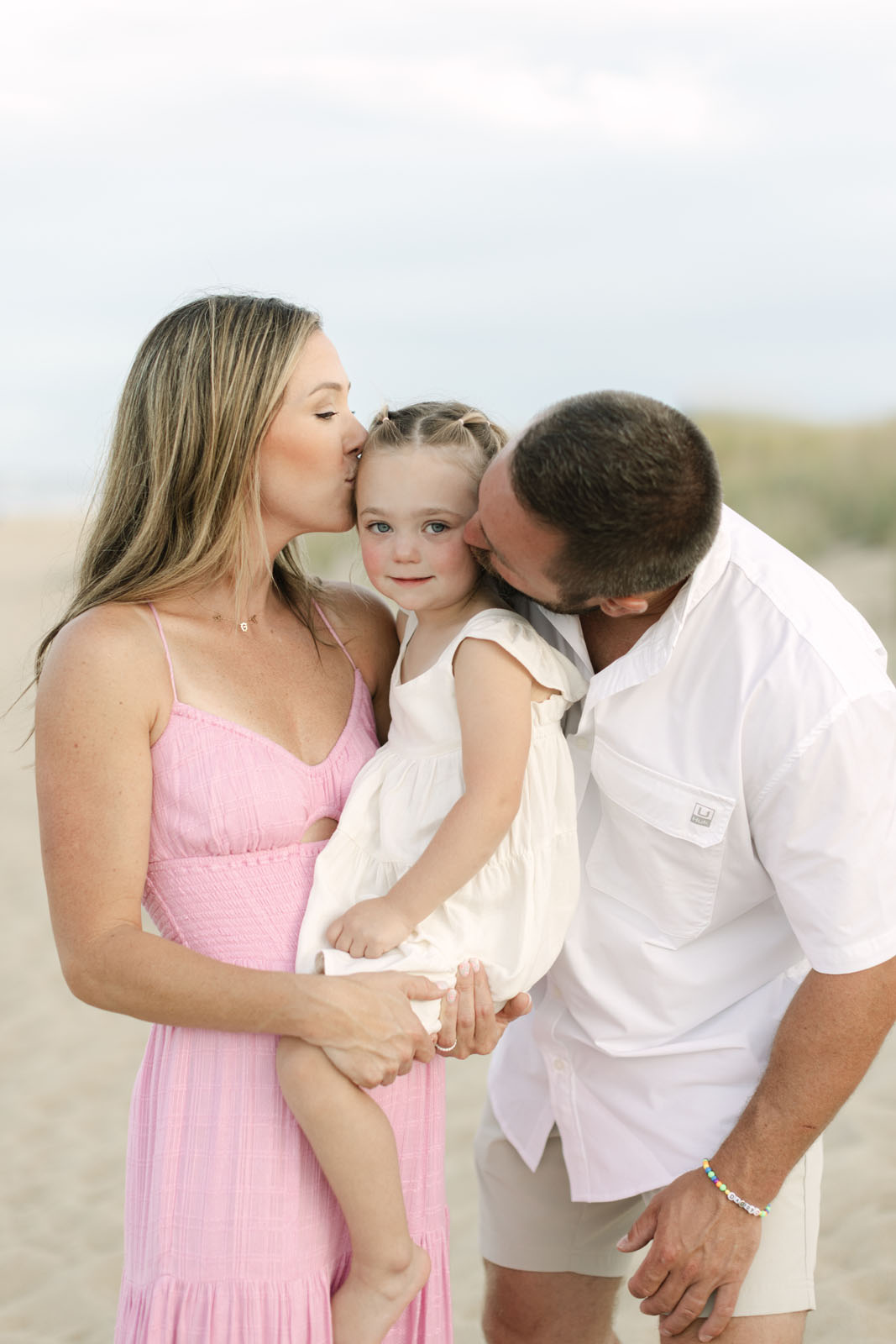 family of three at the beach in Corolla nc, candid moment