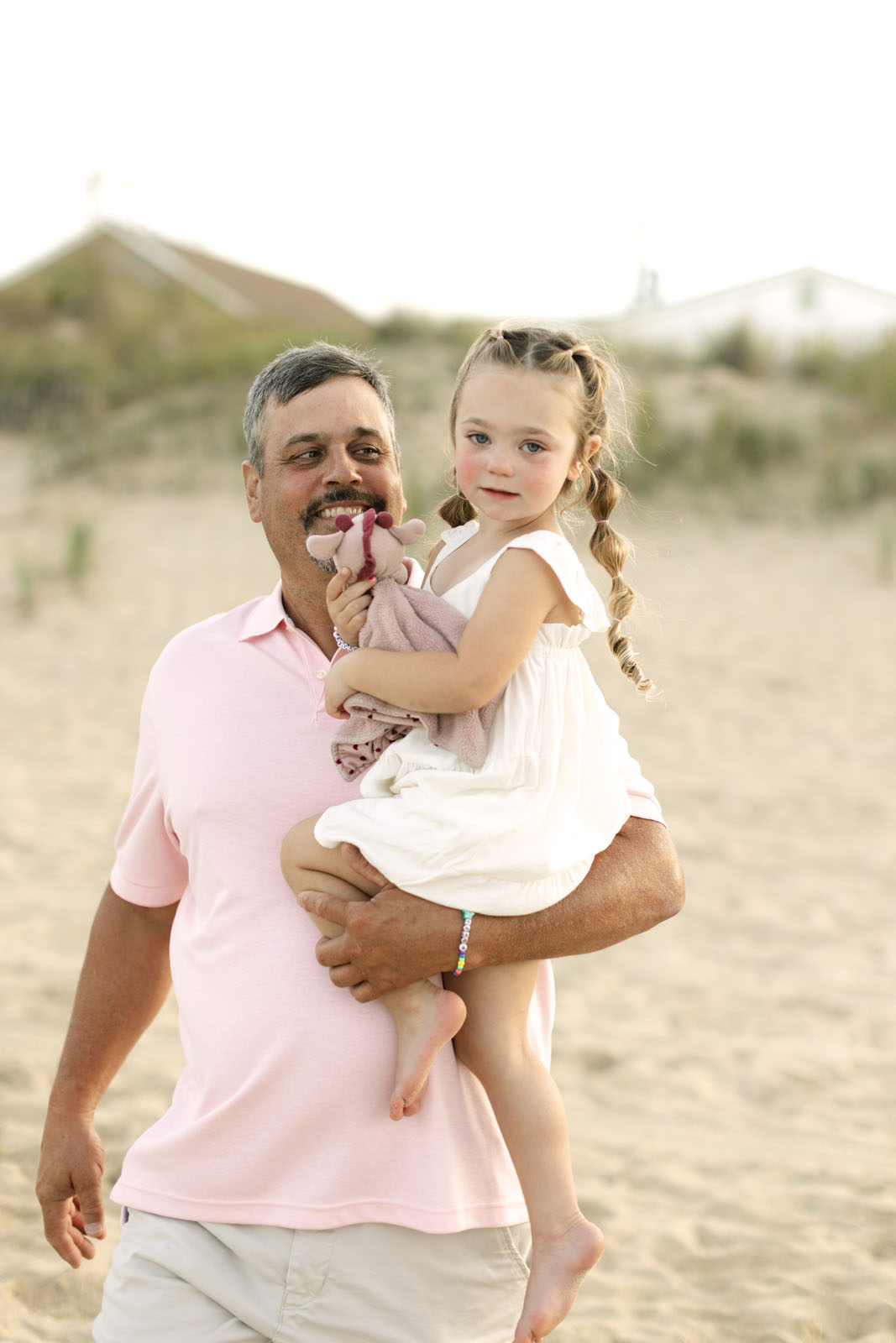 Grandfather holding granddaughter at the  Corolla nc beach