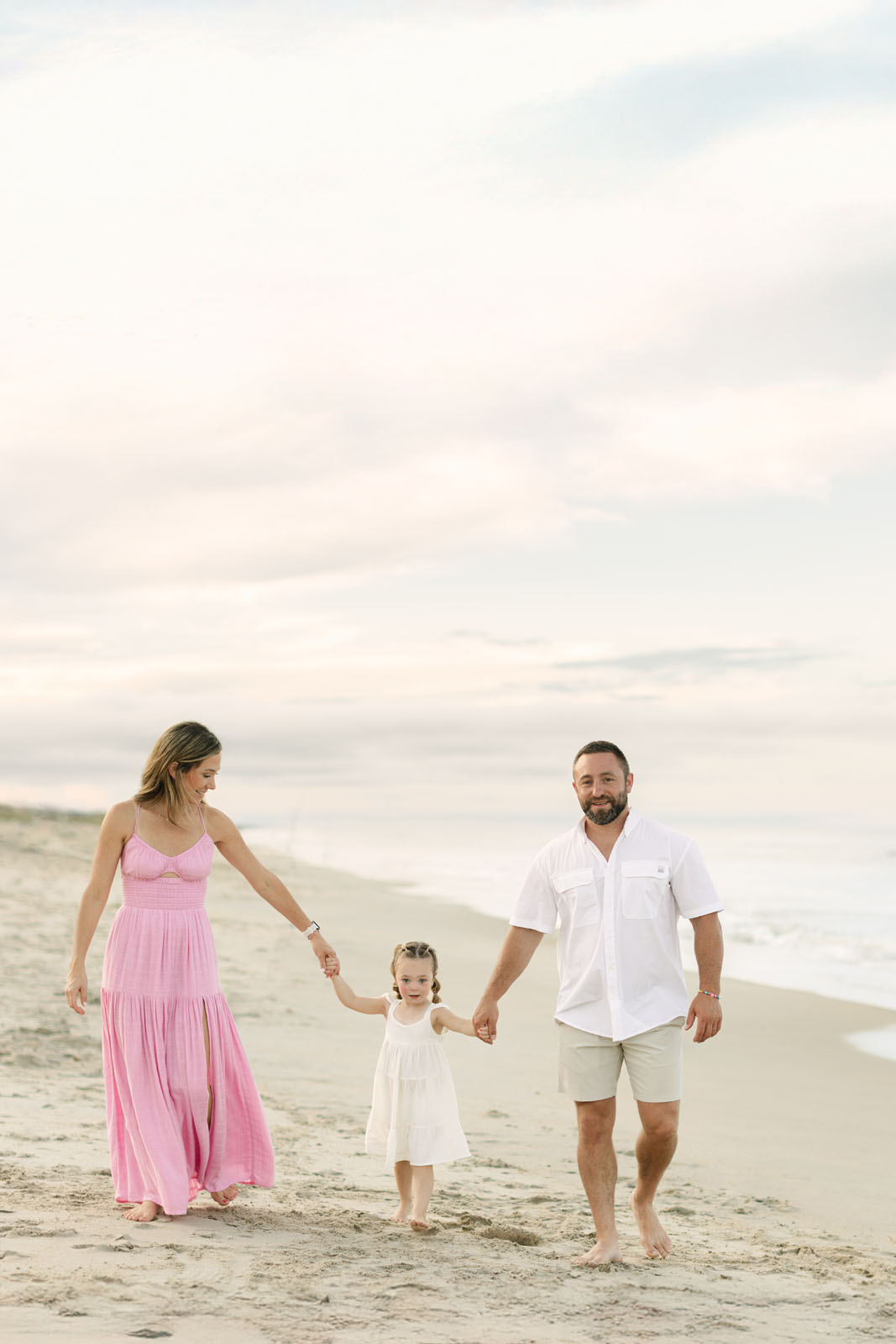 Family is walking on the beach of Corolla, NC