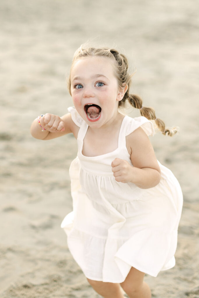 little girl running on the beach in Corolla nc