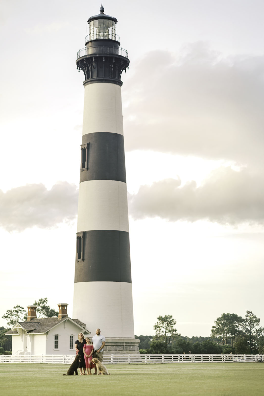 Family portrait with dogs near Bodie Island Lighthouse on the Outer Banks