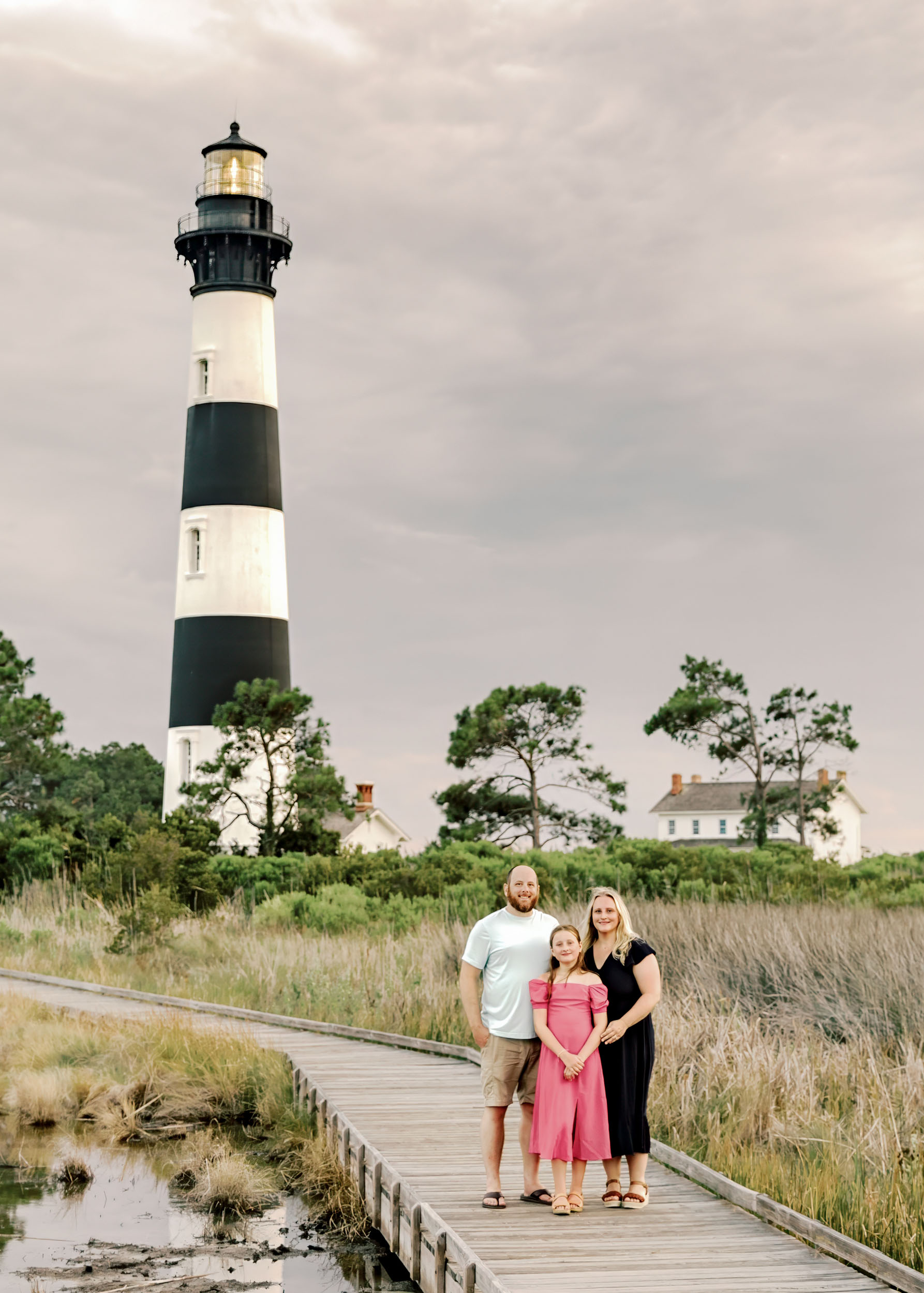 Family portrait near Bodie Island Lighthouse boardwalk in Nags Head on the Outer Banks