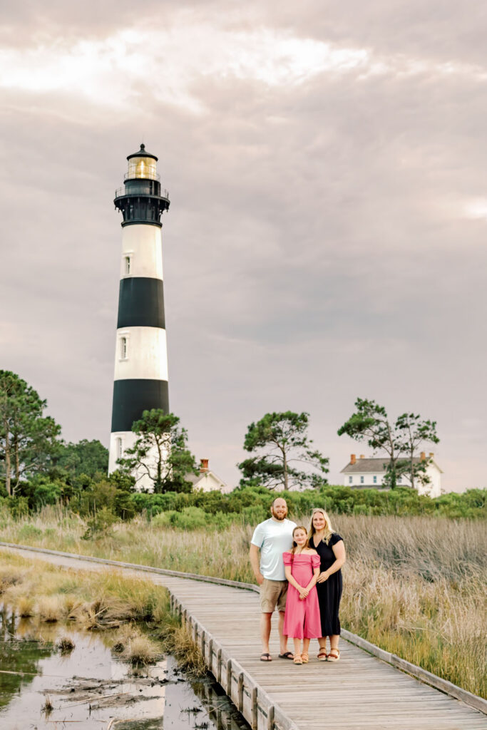 Family portrait near Bodie Island Lighthouse boardwalk in Nags Head on the Outer Banks