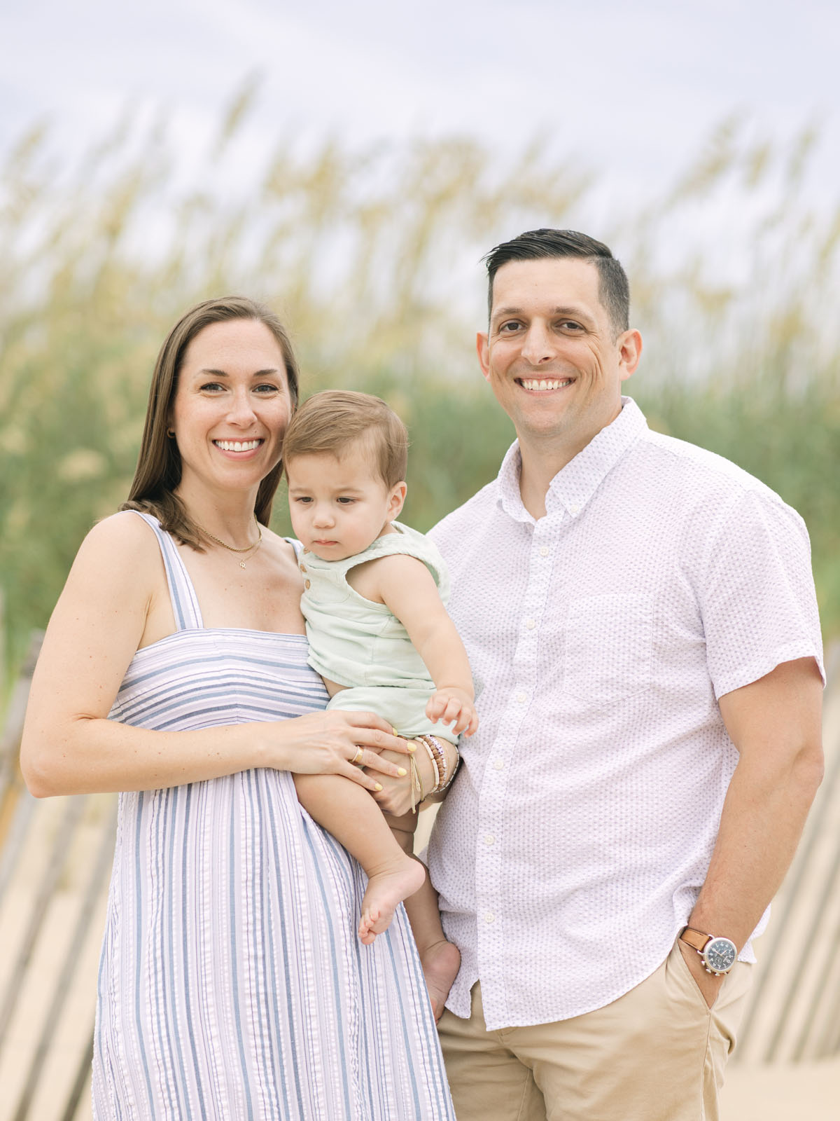 Parents holding their toddler during an Outer Banks family photo session