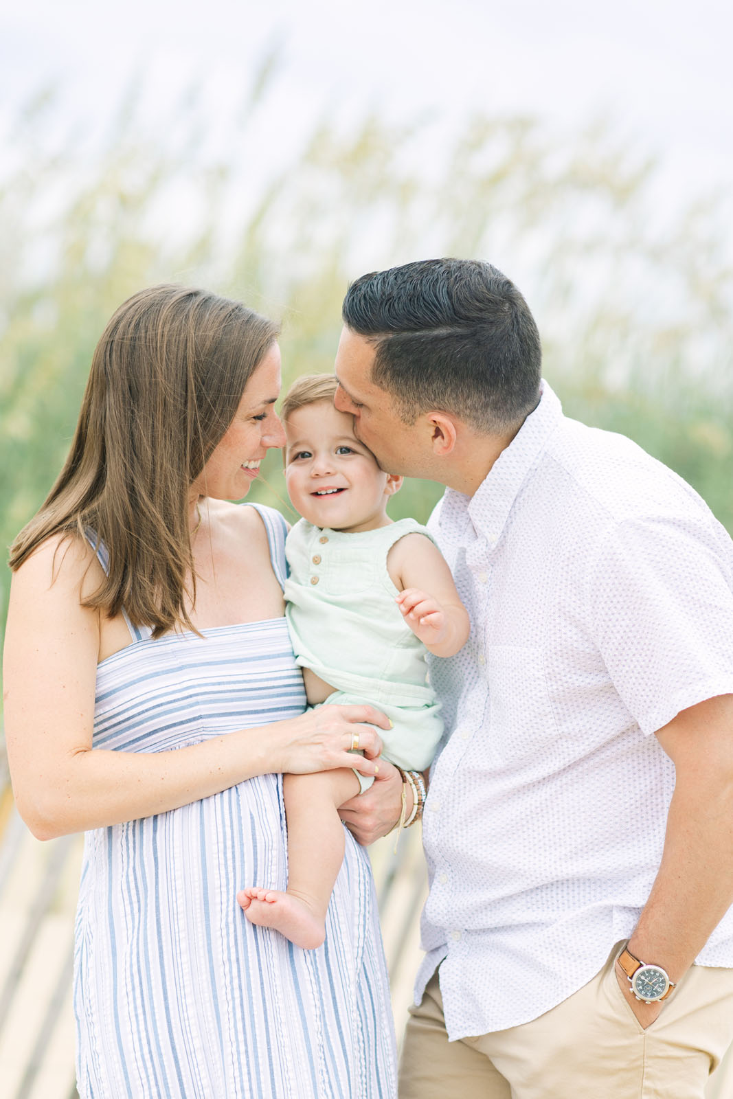 Candid moment of parents with their baby during a beach family session