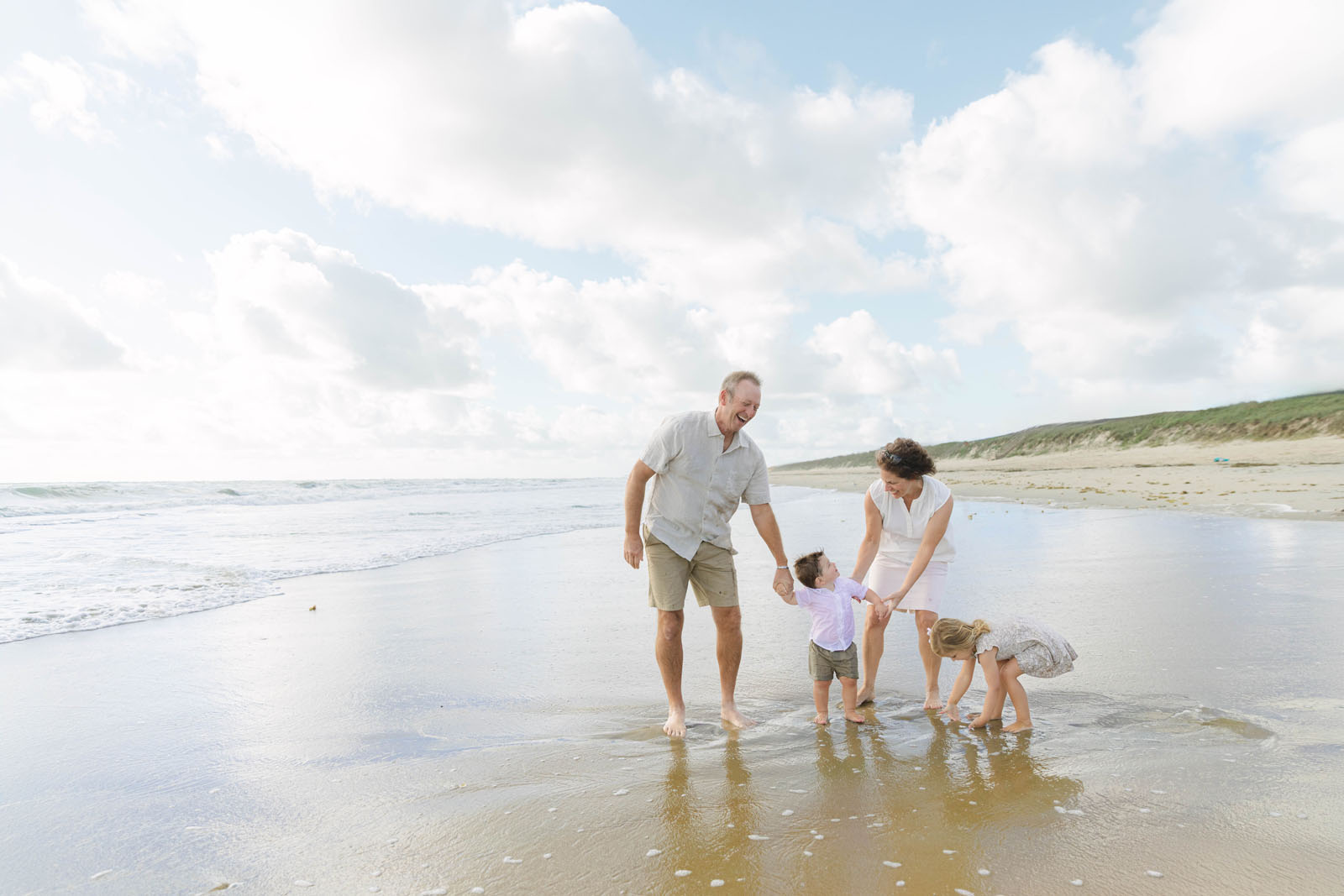 Grandparents spending time with grandchildren on the beach in Kitty Hawk