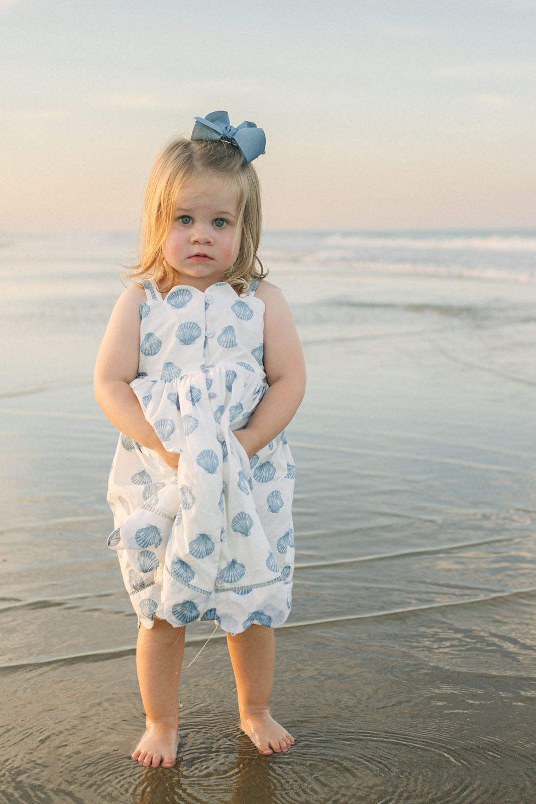 Child standing on the beach at sunset on the Outer Banks